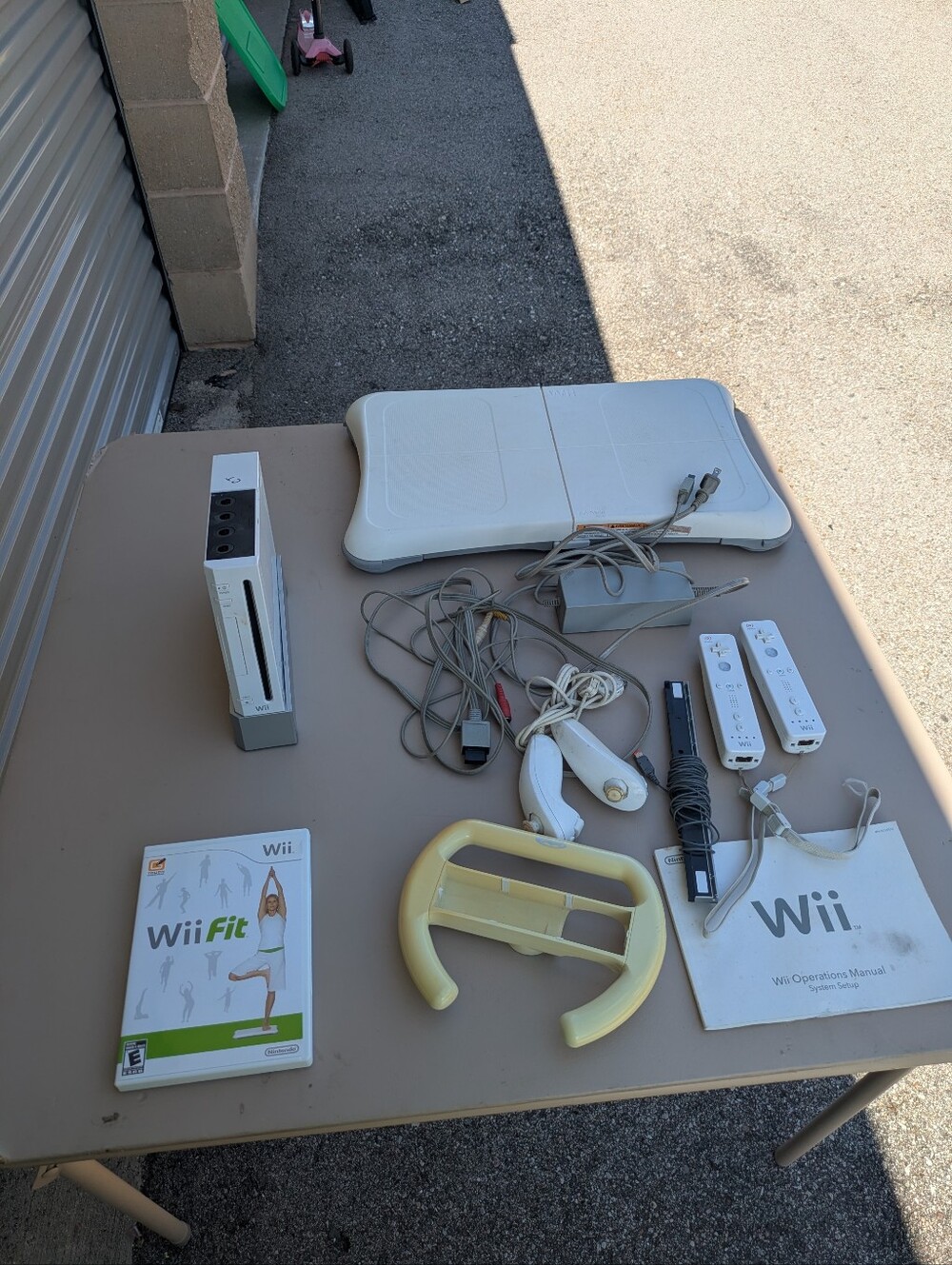 Nintendo wii with wii fit game and board plus controllers and nun chucks